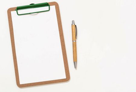 Wooden clipboard with empty paper and wood cover pen isolated cutout on white background.の写真素材