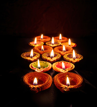 Diwali. Deepavali Hindu festival of lights. Clay diya candle. Oil lamp lit on dark background