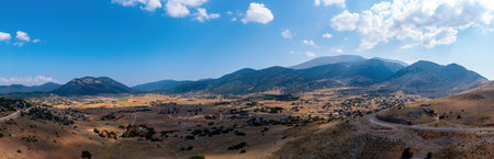 Livadi Arachova Greece, aerial panorama. Winter houses on a mountain Parnassos plateau, near Greek resort, cloudy blue skyの写真素材