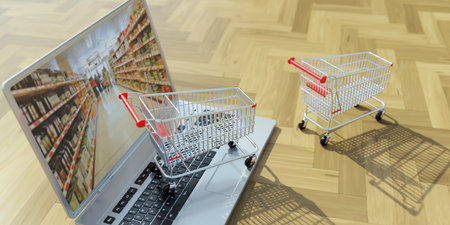Supermarket shopping cart on a computer laptop. Ecommerce, online order and delivery. 3d renderの写真素材