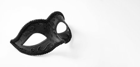 Carnival Venetian mask black color and shiny glitter decoration isolated on white backgroundの写真素材
