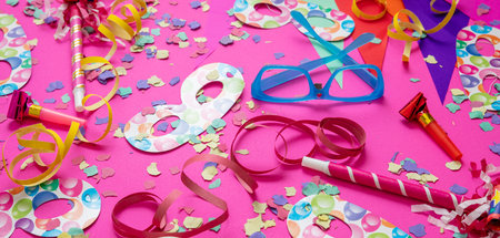 Carnival birthday party. Confetti and serpentines on bright pink background. Holiday celebration and decorationの写真素材