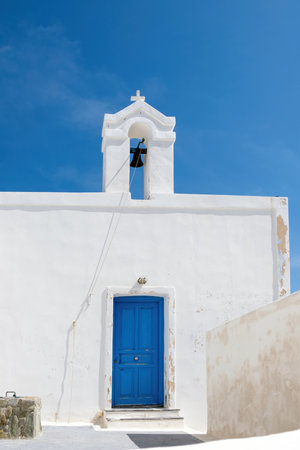 Cyclades, Greece. Small white church and belfry against blue sky, sunny day. Kea islandの写真素材