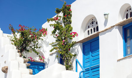 Tinos island Greece. Cycladic architecture at Volax village. Marble lintels, pink bougainvillea, whitewashed walls and stairsの写真素材