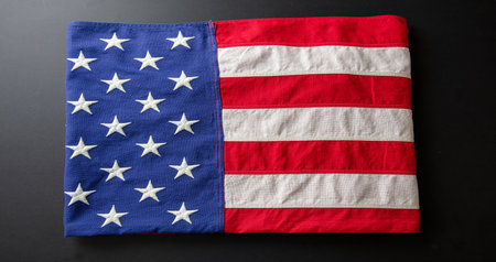 American flag folded on black abackground, top view. US America National Holiday, Memorial and Independence dayの写真素材