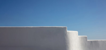 Exterior white building empty wall touches clear blue sky background, Greece Cyclades island architecture, freedom, hope, success. Copy spaceの写真素材
