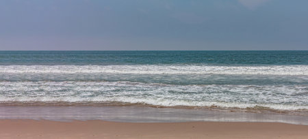 Empty sandy Venice beach, Pacific ocean coastline Los Angeles, California USA. Blue clear sky and...