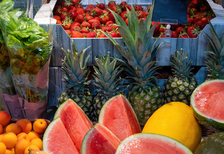 Fruit stand with strawberries, pineapples, and moreの写真素材