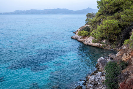 Agistri Island Greece. Rocky landscape covered with pine tree, cliff, crystal transparent sea water, blue sky, summer destination. Copy spaceの写真素材