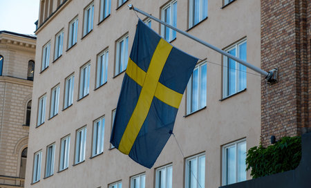 Sweden national flag waving on a Stockholm city building facade, close up viewの写真素材