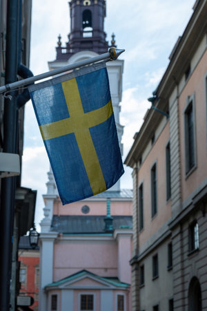 Sweden national flag waving on a Stockholm city building facade, close up viewの写真素材