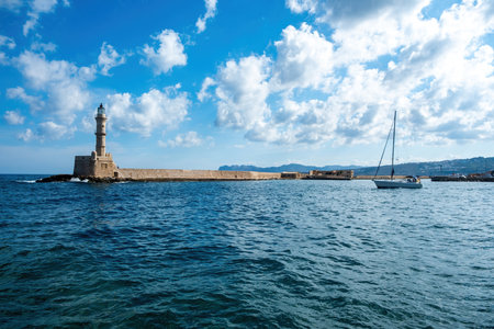Crete island, Greece. Lighthouse, beacon at Venetian harbour in Old Town of Chania, blue sky, sunny day.の写真素材