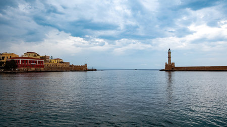 Crete island, Greece. Lighthouse, beacon at Venetian harbour in Old Town of Chania, cloudy skyの写真素材