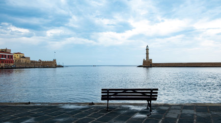 Crete island, Greece. Lighthouse, beacon at Venetian harbour in Old Town of Chania, cloudy skyの写真素材
