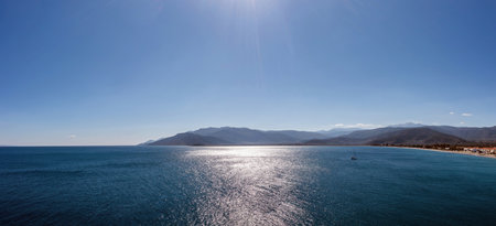 Paralio Astros port, Arcadia, Peloponnese, Greece. Aerial drone view of sparkle from sunbeam vast Mediterranean sea water, blue sky background.の写真素材
