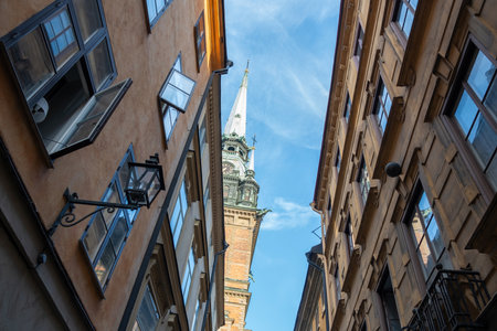 German or St. Gertrude Church, Tyska Kyrkan in Gamla Stan Old Town Stockholm Sweden. Upper part of building and tower with the clock. Under viewの写真素材