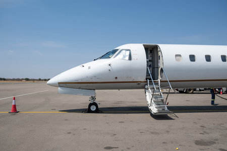 Private Jet plane landed at airport runway, blue sky background. Luxury transportation conceptの写真素材
