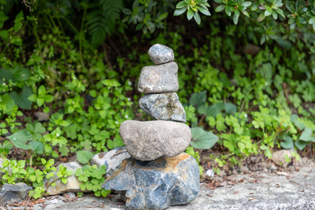 Zen stones, balance tower, green leaves background,  japanese garden