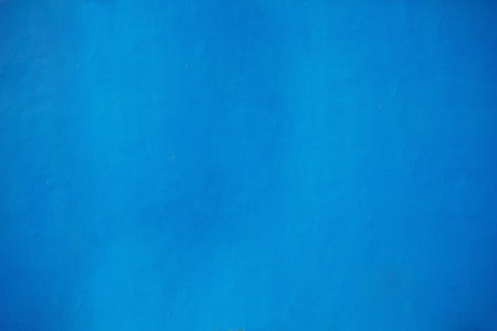Bright blue color wall background texture. Exterior building facade painted wallの写真素材