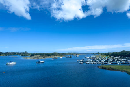 Knysna lagoon marina South Africa. Boats anchored on calm water, blue sky with scattered cloudsの写真素材
