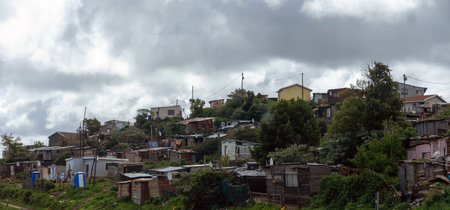 South Africa informal settlement on a hill, houses made of corrugated metal sheet and cardboard,...