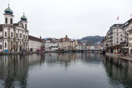 Switzerland, Lucerne. Old city, Altstadt architecture. Jesuit Church and other historic buildings on the banks of Reuss River.の写真素材