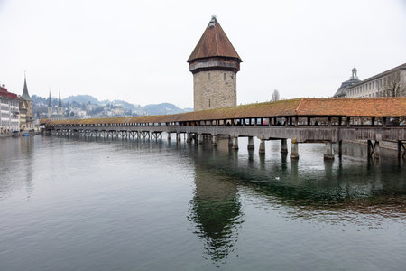Switzerland, Lucerne. Chapel Bridge and Water Tower. Oldest covered bridge in Europe, cloudy skyの写真素材
