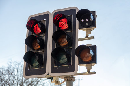 Traffic lights red color. Stoplight for cars on a city street, blue sky background