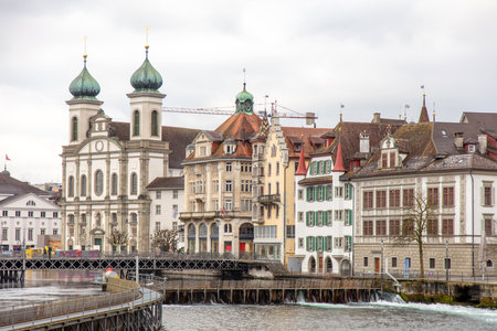Switzerland, Lucerne. Old city, Altstadt architecture. Jesuit Church and other historic buildings on the banks of Reuss River.の写真素材