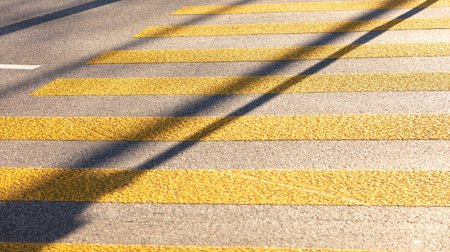 Pedestrian crossing, yellow color stripes crosswalk, closeup viewの写真素材