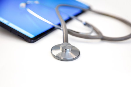 Telemedicine, medical stethoscope and digital tablet on white, closeup viewの写真素材