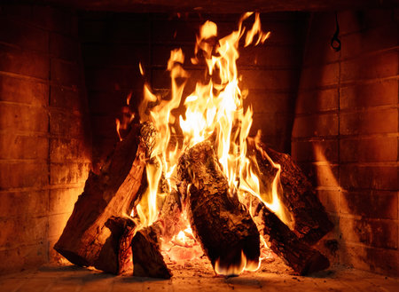 Fire burning in a fireplace, wood logs and flames. Warm home, heat. Christmas holidayの写真素材