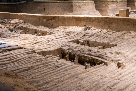 Terracotta Army Warriors archaeological site. Xian, China. Partially excavated section. Undulating earth covers buried fragmentsの写真素材