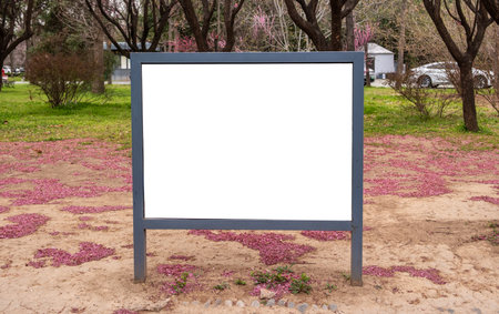 Signboard white blank display in a park, empty sign board template for information and advertiseの写真素材
