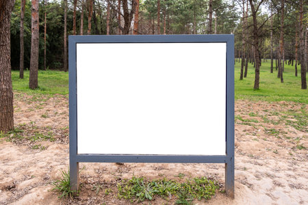 Signboard white blank display in a park, empty sign board template for information and advertiseの写真素材