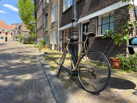 Bicycle parked on sidewalk in front of brickwall building in Delfshaven. Biking in Netherlands Hollandの写真素材