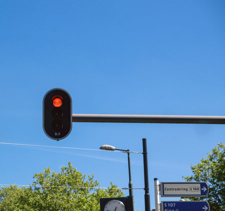 Red traffic light for cars, blue sky and Dutch text sign meaning Center ring. Rotterdam Netherlandsの写真素材