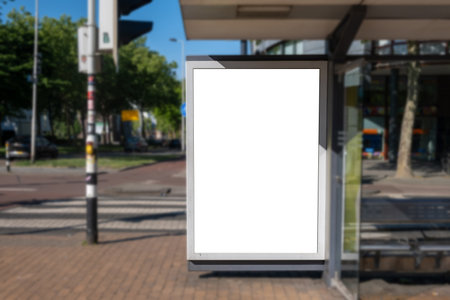 Blank advertise display stand, empty vertical billboard on a bus stop, sunny day. Advertisement template in Netherlandsの写真素材