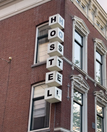 Hostel sign on brick wall building facade, Netherlands, Holland. Travel and accomodation conceptの写真素材