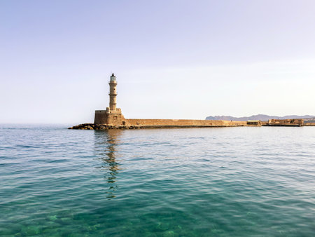 Chania Crete. Lighthouse at old venetian port, blue sky and calm seaの写真素材