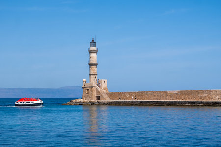 Chania Crete. Lighthouse at old venetian port, blue sky and calm seaの写真素材
