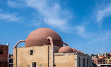 Chania Crete island. Hassan Pascha mosque at the old venetian harbour, blue sky, sunny dayの写真素材