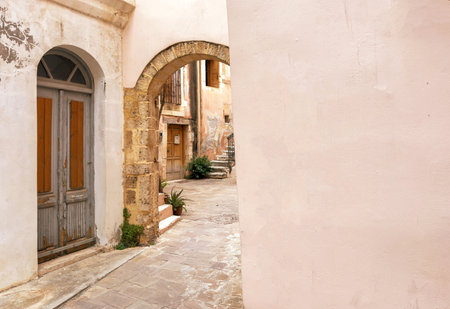 Chania old town architecture. Wooden door and stone arch pastel color walls, copy space. Crete island, Greeceの写真素材