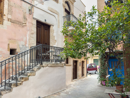 Chania old town architecture. Crete island, Greece. Narrow cobblestone street, stone walls, traditional buildingsの写真素材