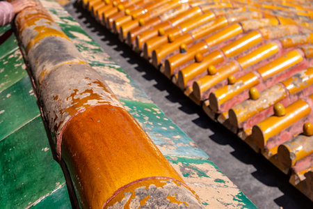 Traditional Chinese roof tiles, old faded glazed ceramic roofing tiles closeup view