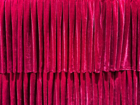 Red velvet curtain backdrop on a theater stage. Closed luxury drapes backgroundの写真素材