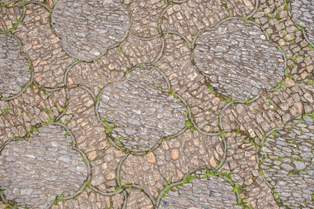 Traditional cobblestone pavement background, smooth river stones arranged in pattern. Ancient Chinese garden paving, aged textureの写真素材