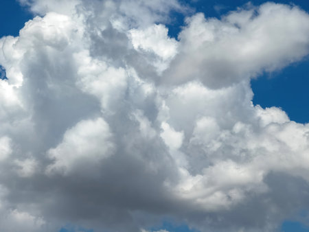 Blue sky with clouds background, sunny day. White and grey fluffy cloudscape, nature landscapeの写真素材