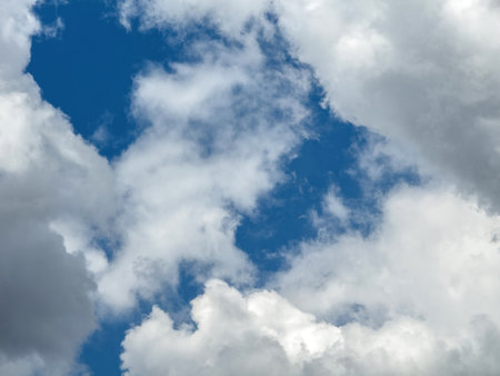 Blue sky with clouds background, sunny day. White and grey fluffy cloudscape, nature landscapeの写真素材