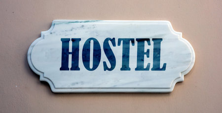 HOSTEL text marble sign on grey brown wallの写真素材
